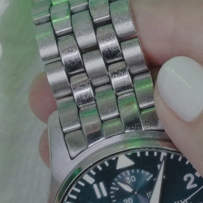 Step 1, spray: Sparklean sprayed onto a steel watch bracelet (real footage, muted 2-second loop)
